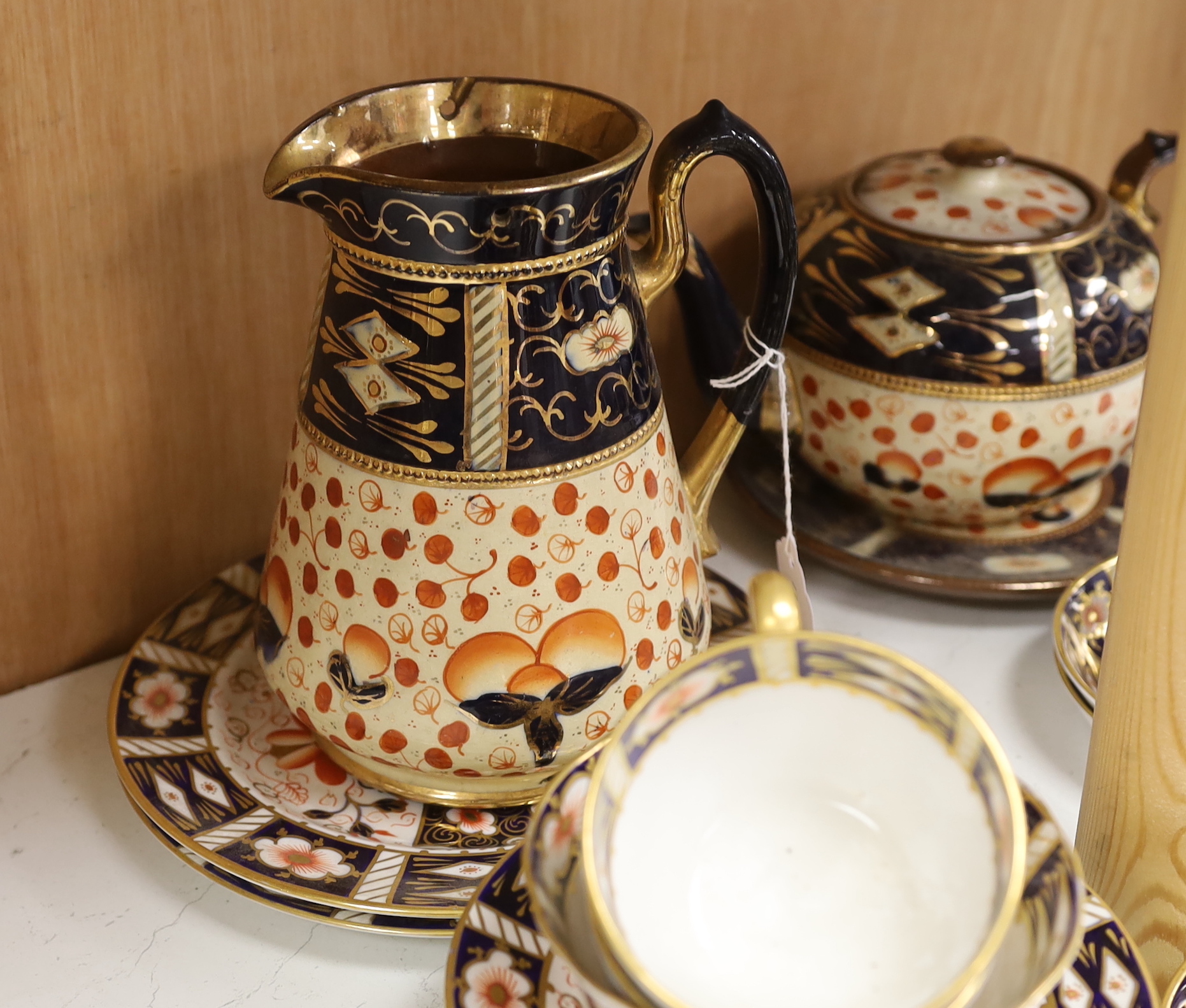 A Royal Crown Derby Imari pattern 2451 part tea set together with an Imari style jug, teapot and stand, largest 18cm high